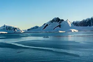 Peninsula Prints: early morning sun on jabet peak (r) and noble peak (l) on wiencke island