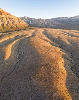 Cultural Sites Prints: Early morning sunlight illuminates a beautiful mountain landscape that rises from the desert in Red Rock Canyon not far