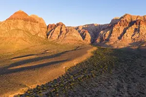 Early morning sunlight illuminates a beautiful mountain landscape that rises from the desert in Red Rock Canyon not far from Las Vegas, Nevada
