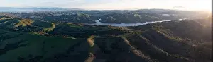 Early morning sunlight shines on the green hills of the east bay, near San Francisco Bay. These hills in California turn green during winter months