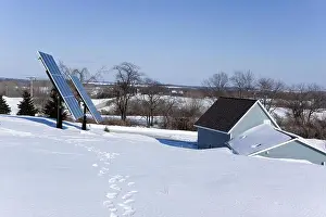 Green Building Prints: Earth sheltered home with photovoltaic solar panels in a winter rural setting