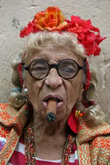 Elderly Prints: Eccentric elderly Cuban woman Graciela Gonzalez also known as Granny Puretta smokes cigar at age 84 in the historical