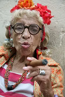 Elderly Prints: Eccentric elderly Cuban woman Graciela Gonzalez also known as Granny Puretta smokes cigar at age 84 in the historical