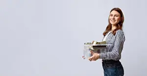 Urban Living Prints: Eco-conscious woman participates in recycling during a sunny afternoon