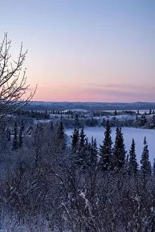 Hoof Prints: Edge of icy lake under colorful pink sky on a winter evening near Delta Junction, Alaska