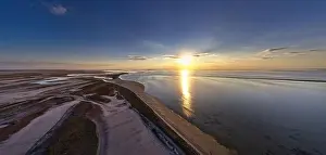 Hatching Prints: The edge of the sea in the evening sun. Camping beach. Drone shot 4K