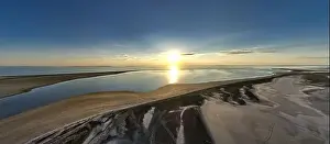 Hatching Prints: The edge of the sea in the evening sun. Camping beach. Drone shot 4K