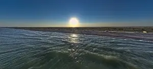 The edge of the sea in the evening sun. Camping beach. Drone shot 4K