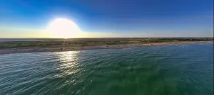 Hatching Prints: The edge of the sea in the evening sun. Camping beach. Drone shot 4K