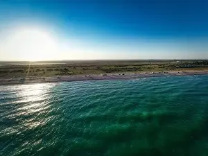 Hatching Prints: The edge of the sea in the evening sun. Camping beach. Drone shot 4K
