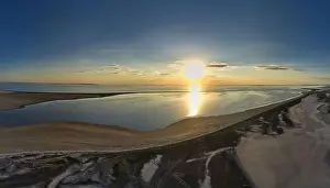Hatching Prints: The edge of the sea in the evening sun. Camping beach. Drone shot 4K