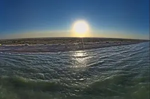 The edge of the sea in the evening sun. Camping beach. Drone shot 4K