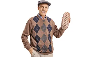 Loaf Prints: Elderly man holding a loaf of bread isolated on white background