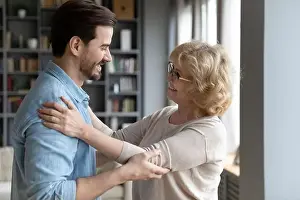 Offspring Prints: Elderly mother admires matured son looking at him enjoy meeting