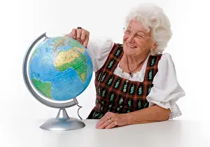 Examine Prints: Elderly woman with a globe