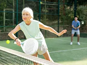 Practicing Prints: Elderly woman padel tennis player training on court