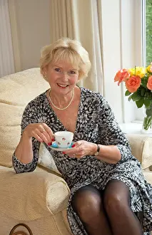 Comfy Prints: Elderly woman sitting in a comfortable chair having a cup of tea