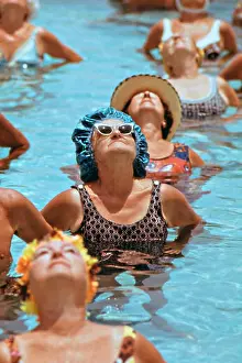 Elderly Prints: Elderly women enjoy water aerobics exercises in the swimming pool at the Century Village Retirement Community February