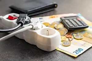 Cord Prints: Electric plug, euro money and calculator on the black table