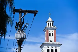 Transformer Prints: Electric Transformer With Cables and Bell Tower of a Church in Blue Sky