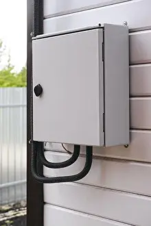 Siding Prints: An electrical panel with an electric wires in it on a wall outside the house