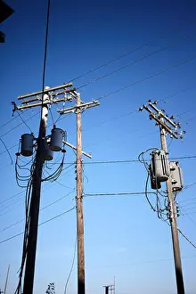 Tangled Prints: Electricity poles with connectors and insulators with high voltage cables distributing power