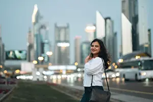 High Rise Prints: Elegant business woman in Dubai with Dubai skyline background