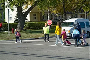 Educator Prints: Elementary school crossing guard provides safety to children crossing busy streets roads highways while walking home