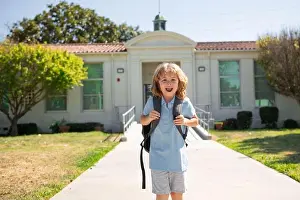 Back To School Prints: Elementary school kid running at school. Knowledge day. Go to school