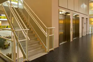 Archway Prints: An elevator and glass staircase in a modern metropolitan building