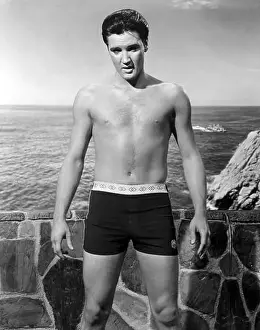 The King Prints: Elvis Presley in swimming trunks (age 28) during the making of Fun in Acapulco, 1963