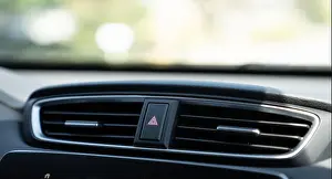 Dials Prints: Emergency light button on dashboard of car between air vents