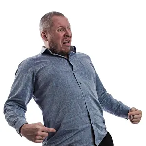 Shocked Prints: emotional actor man in a gray shirt posing on a white background in studio