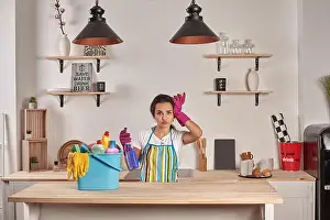 Polishing Prints: Emotional Housekeeper. Beautiful woman cleaning kitchen