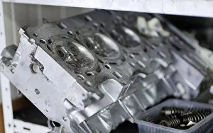 Overhaul Prints: Engine cylinder head is placed on a workshop shelf with visible combustion chambers and valve seats