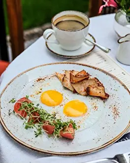 Delightful Prints: Enjoy a delicious breakfast featuring eggs, grilled chicken, and a nice cup of coffee