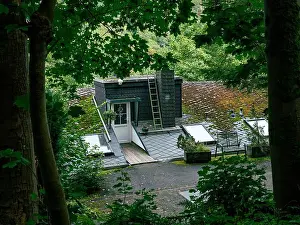 Wind Turbine Prints: The entrance to a house on a mountain where the entrance door can be found in the roof