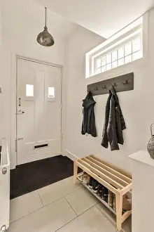 Rack Prints: a entryway with coat rack and shoes hanging on the wall in front of the door to the entranceway