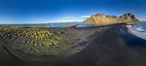 Stokksnes Prints: Epic aerial drone view flying over landscape of the black sand beach in Stokksnes on a sunny day