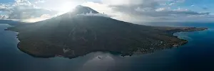 Active Volcano Prints: Evening sunlight peeks around the active volcano of Iliape in the Lesser Sunda Islands of Indonesia
