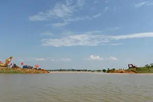 Flooding Prints: Excavators and bulldozers are used to fill up the breach of a dyke along the flooded Bintian River in Poyang county