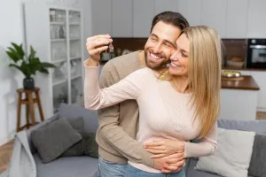 Embracing Prints: Excited caucasian couple in love move in a new apartment