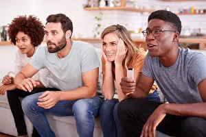 At Home Prints: Excited Group Of Friends Sitting On Sofa And Watching Sports On TV