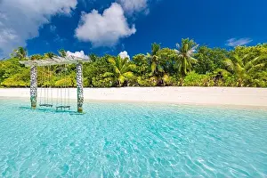 Exotic tropical paradise swings over crystal clear turquoise blue ocean sea water landscape seascape
