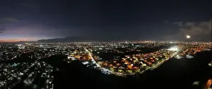 Rica Prints: Experience the enchanting sight of the full moon rising over the iconic La Sabana Park and Costa Rica National Stadium