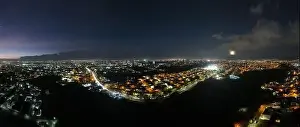 Rica Prints: Experience the enchanting sight of the full moon rising over the iconic La Sabana Park and Costa Rica National Stadium