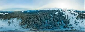 Hill Glacier Prints: Fabulous evening panorama with snow-capped mountains and hills with bright sun and fog on a frosty winter evening
