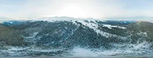 Hill Glacier Prints: Fabulous evening panorama with snow-capped mountains and hills with bright sun and fog on a frosty winter evening