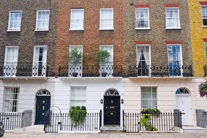 Camden Prints: Facade of Georgian residential town houses made in yellow and red brick in a luxury residential area of West London