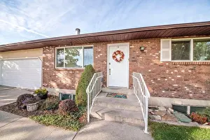 Landscape Garden Prints: Facade of a house with brown bricks siding and garage